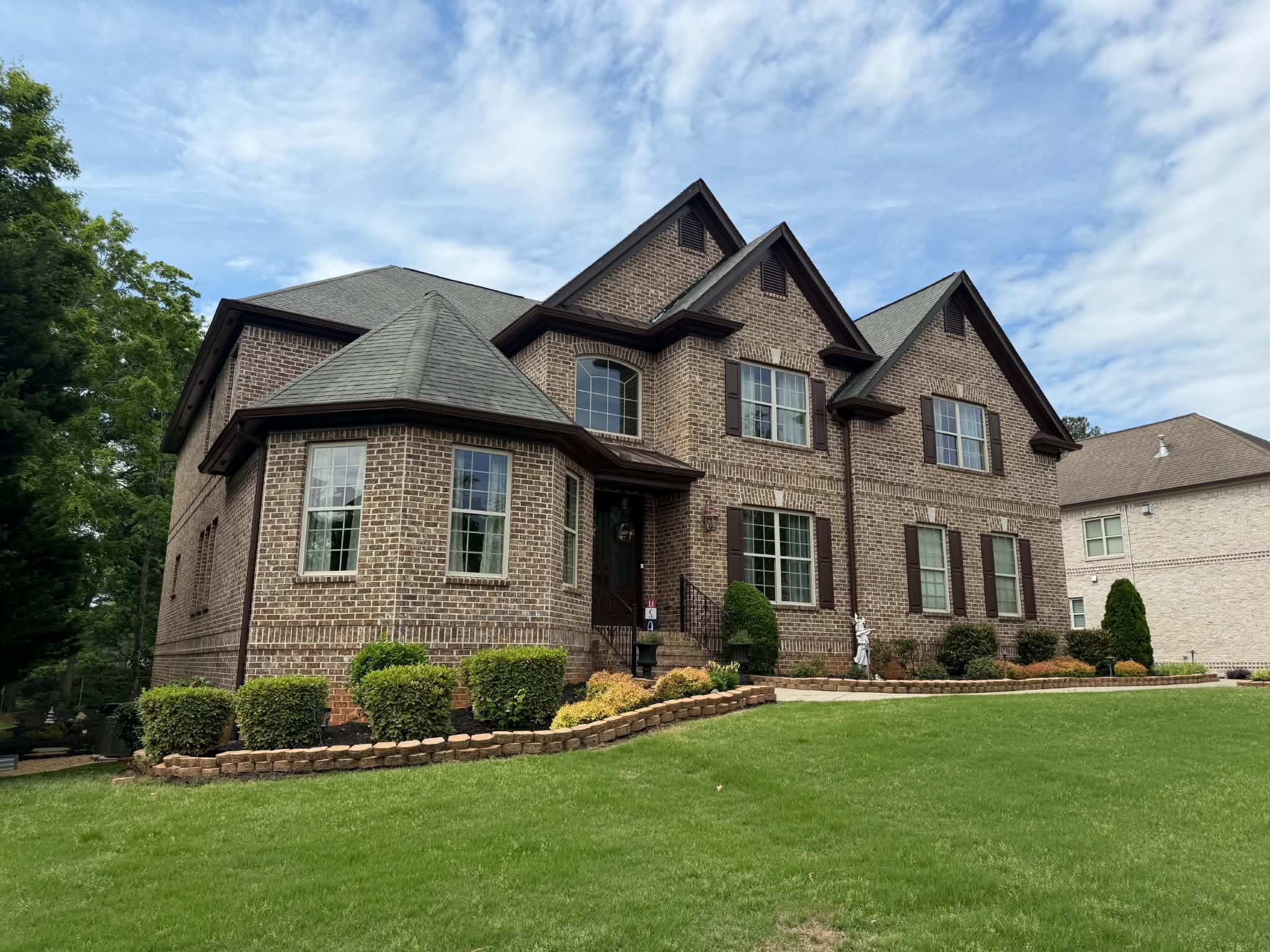 Finished brick home with new roof by Titan Roofing Pro